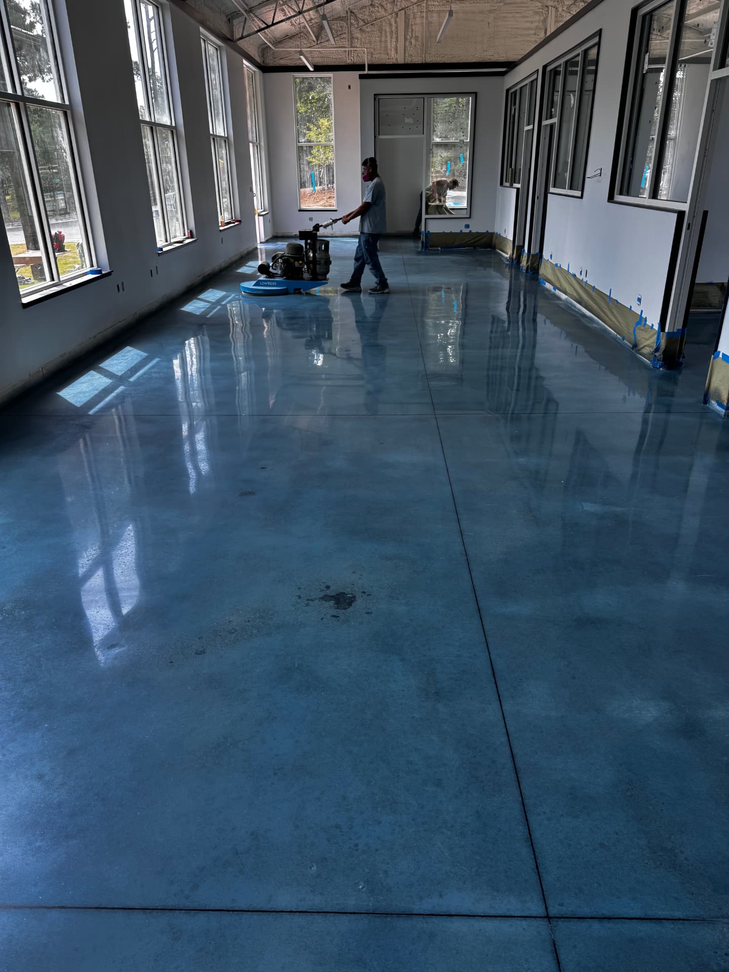 Epoxy & Concrete flooring — Burnishing a stained concrete floor to final gloss in a commercial space — Gainesville, Buford & Flowery Branch GA
