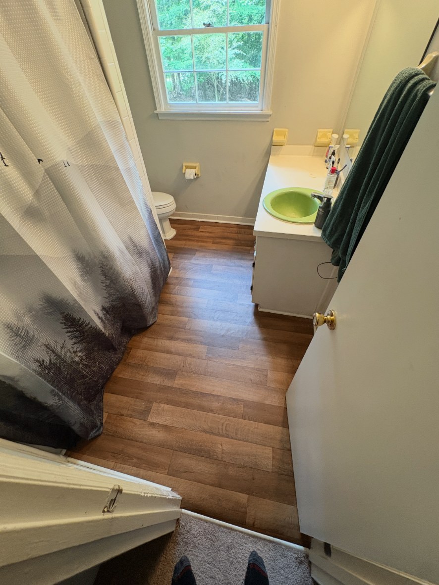 Light oak laminate plank flooring being installed in a North Georgia home