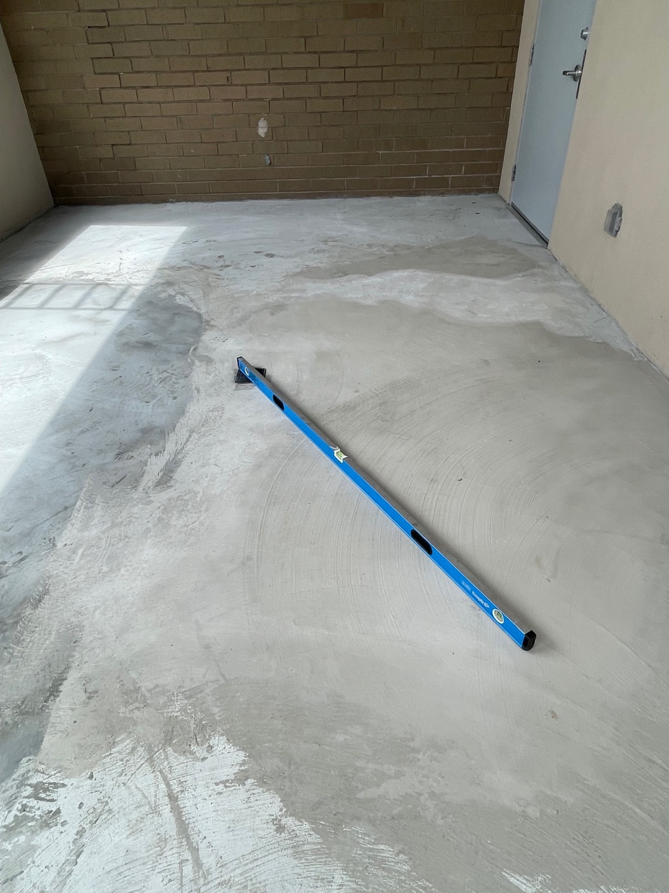 Garage slab diamond ground and checked flat before epoxy coating in Buford GA