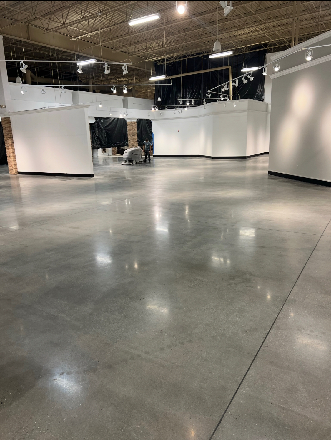 Epoxy & Concrete flooring — Final burnish pass across a polished concrete retail floor before turnover — Gainesville, Buford & Flowery Branch GA